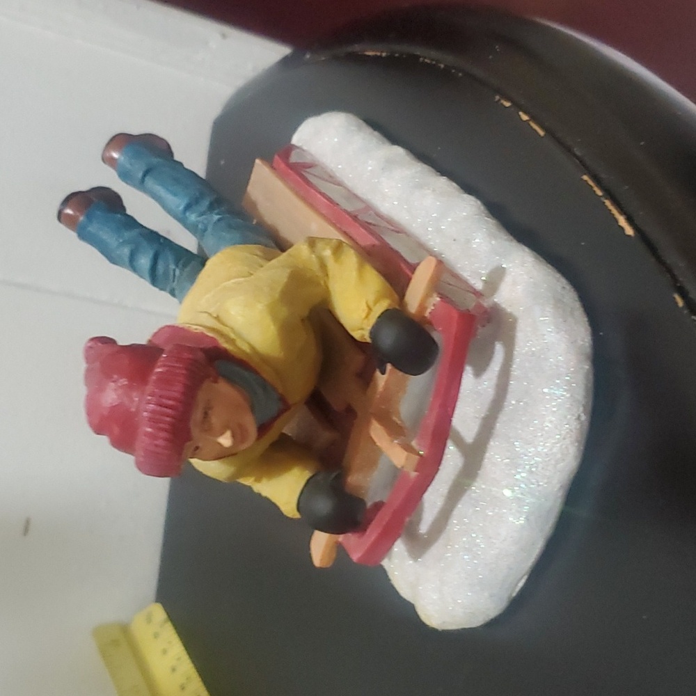 Boy in Blue & Yellow Lying Down on a Sled Holiday Lead Figure